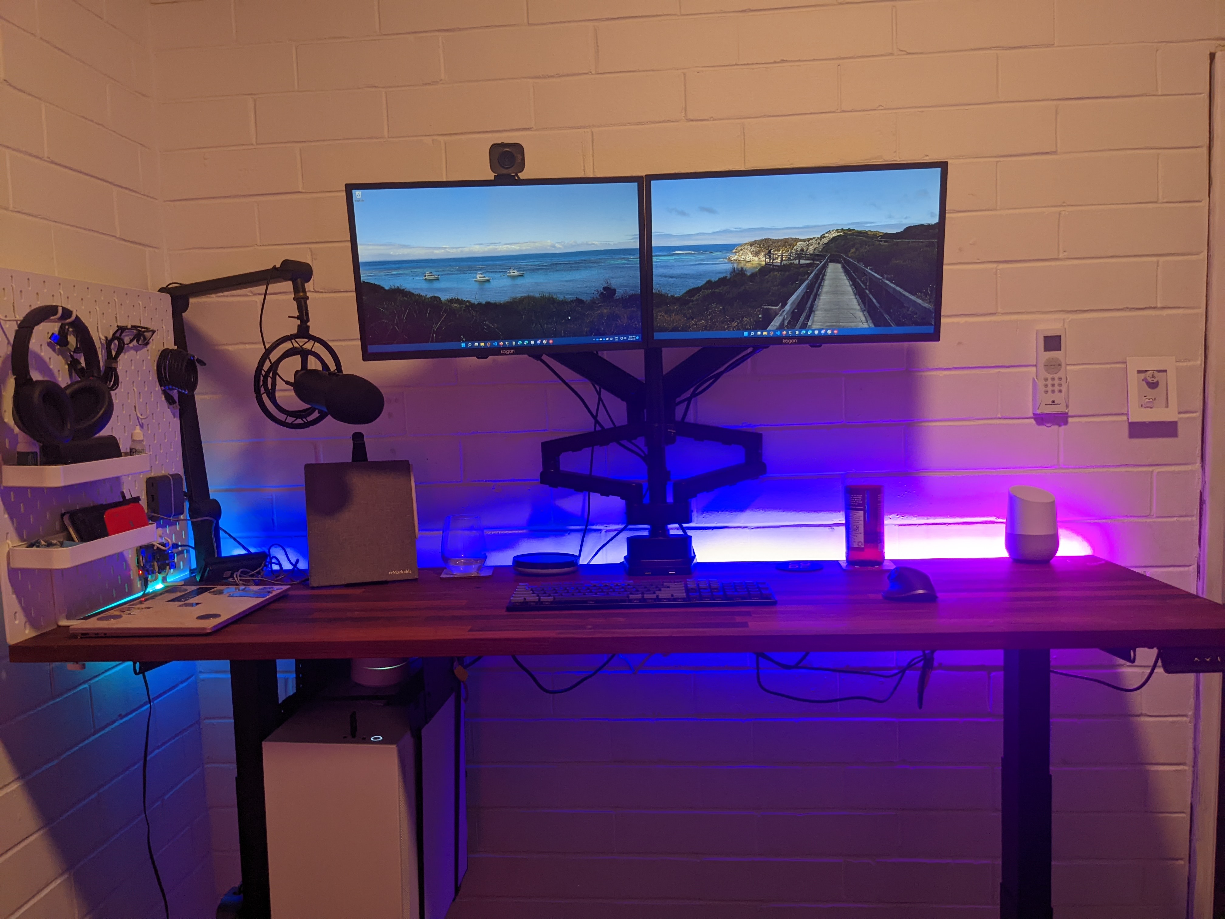 Assembled desk with monitor arms holding the two monitors up, monitor arm is awkwardly positioned so that monitors are too high above the desk